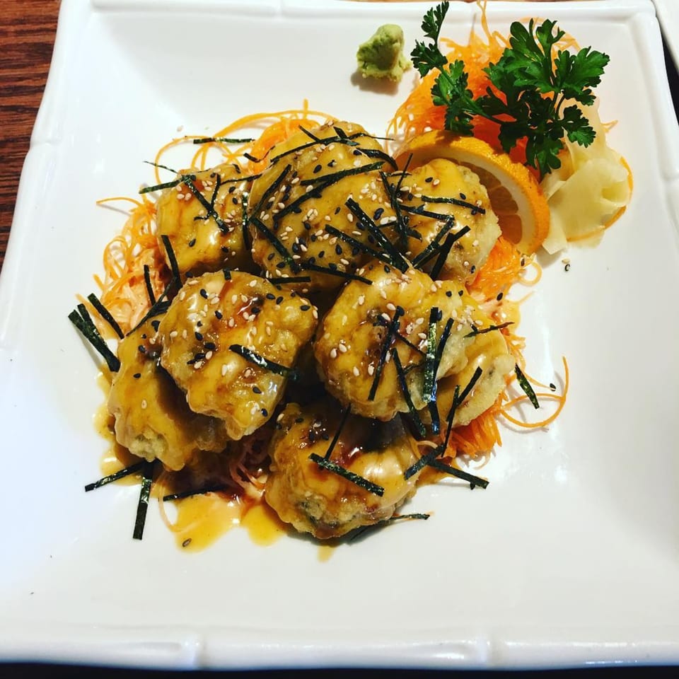 Thai Delight Broadway's fried shrimp with sauce, sesame seeds, seaweed, and shredded carrots.