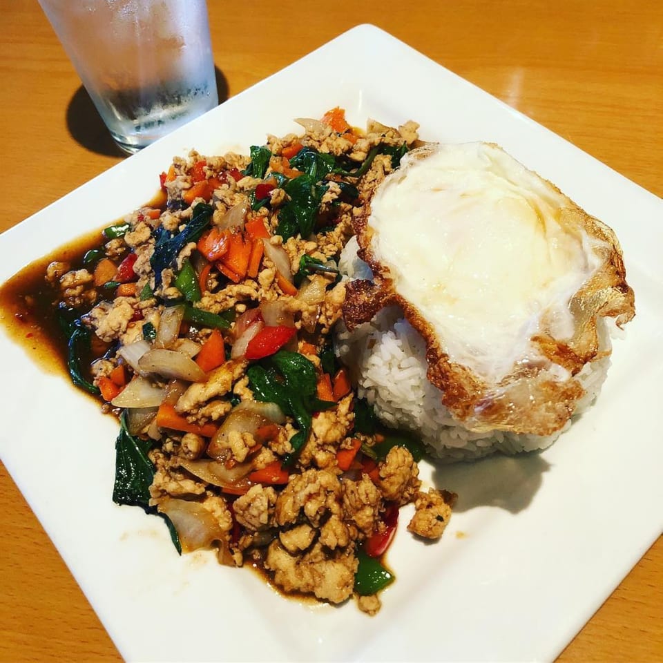 Thai Delight Broadway's Pad Krapow with ground chicken, basil, vegetables, rice, and a fried egg.